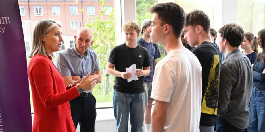 Chancellor Dr Fiona Hill talking to Gosforth Academy students and teacher Keith Wood