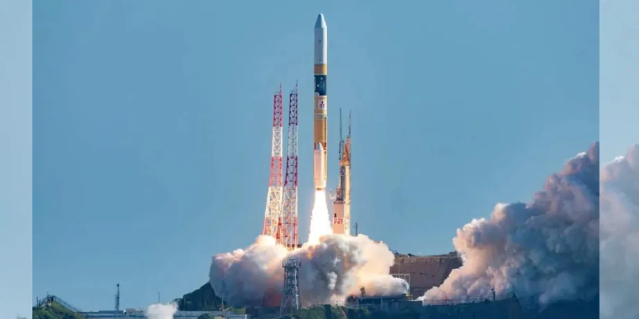 A rocket launching into a blue sky with billows of smoke beneath it