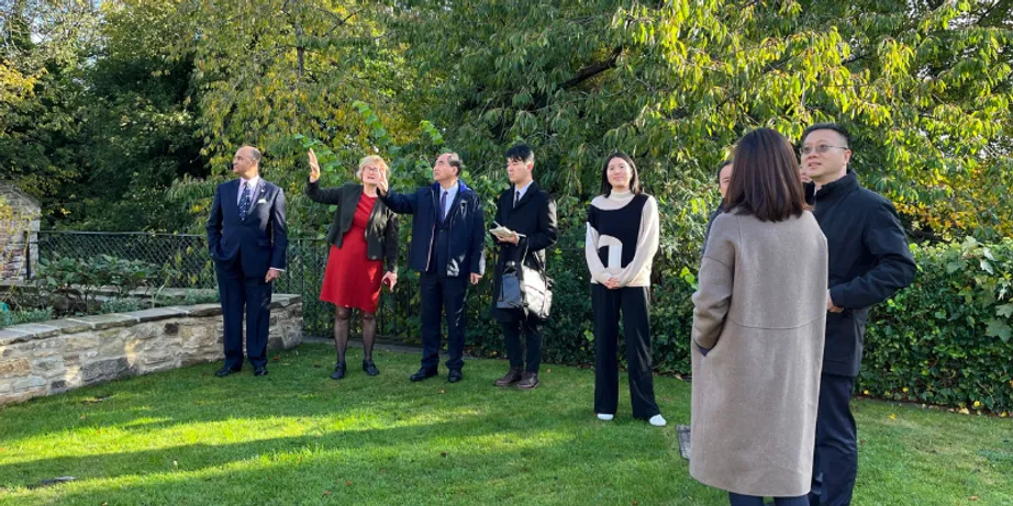A group of smartly dressed people outdoors on a lawn