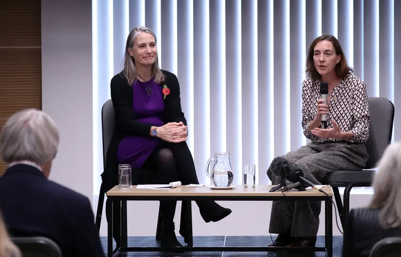 Two woman in front of an audience