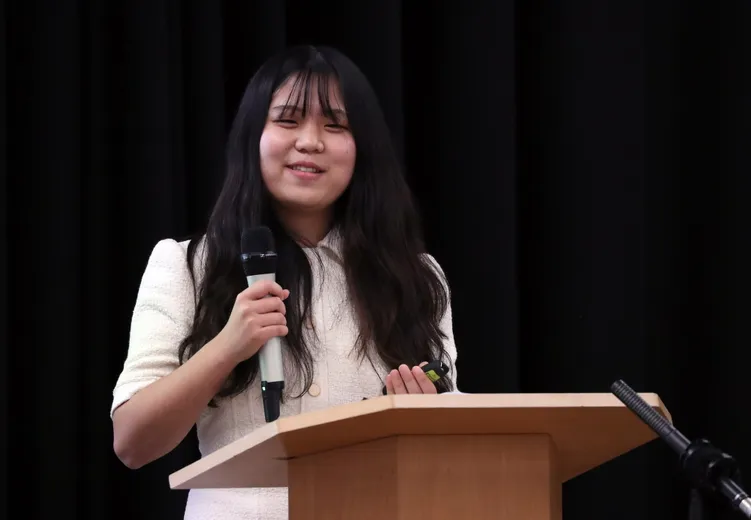 Student talking in front of an audience