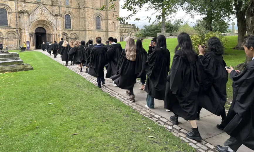 Students walking towards Durham Cathedral's North Door during Matriculation