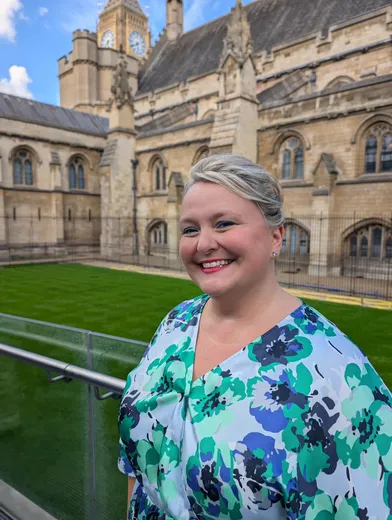Arlene Holmes-Henderson is pictured at Westminster in the background