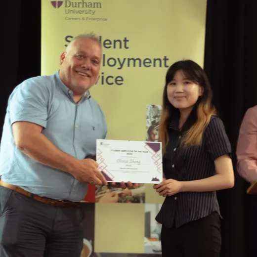 Olivia accepting her award certificate