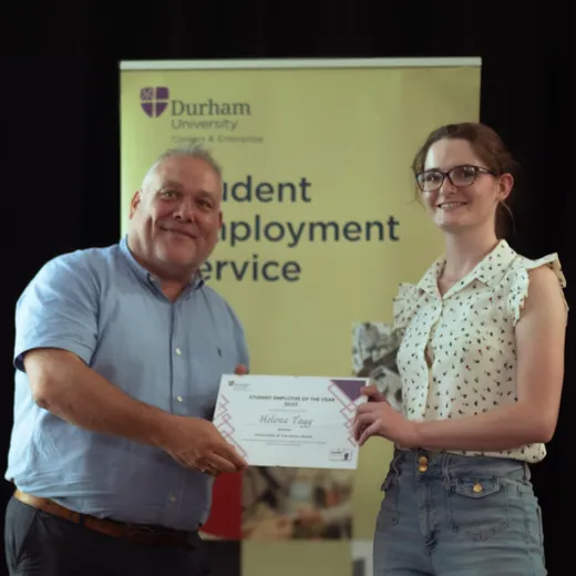 Helena accepting her award certificate.