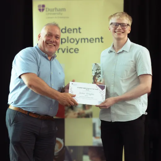 James accepting his award certificate.