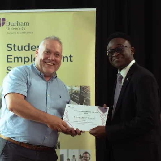 Emmanuel accepting his award certificate